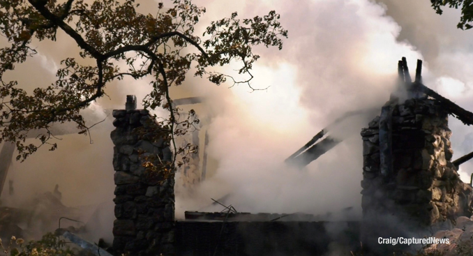 Smoke continues to rise from a destroyed house on Robin Crest Road in Hawthorn Woods near Lake Zurich on Tuesday, October 17, 2023 (PHOTO CREDIT: Craig/CapturedNews)