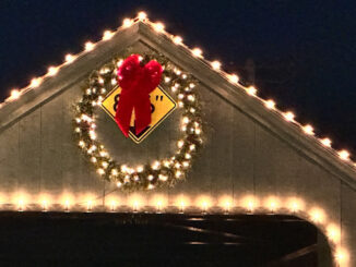 A Christmas or holiday wreath near the top of the Long Grove covered bridge covering the 8'6" clearance warning sign overnight Saturday and Sunday November 18-19, 2023.