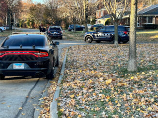 View looking south on Mayfair Road where police vehicles are located behind a white passenger vehicle (not shown) that was stolen from a motorist located at Arlington Heights Road near Interstate 90 on Saturday morning November 18, 2023 (CARDINAL NEWS)