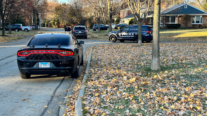 View looking south on Mayfair Road where police vehicles are located behind a white passenger vehicle (not shown) that was stolen from a motorist located at Arlington Heights Road near Interstate 90 on Saturday morning November 18, 2023 (CARDINAL NEWS)