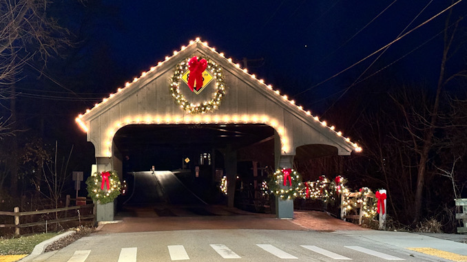 A Christmas or holiday wreath near the top of the Long Grove covered bridge covering the 8'6" clearance warning sign overnight Saturday and Sunday November 18-19, 2023