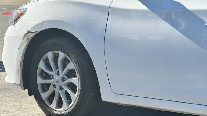 The only property damage visible to a white passenger car after a reported hit-and-run crash and battery to a motorist on Saturday, November 18, 2023 in Arlington Heights (CARDINAL NEWS)