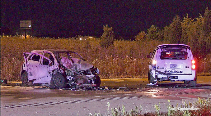 The car that struck a Gurnee Police Department SUV became fully engulfed in fire in the southbound lanes of Route 41 between Washington Street and Route 120 late Thursday night, November 9, 2023 (PHOTO CREDIT: Craig/CapturedNews)