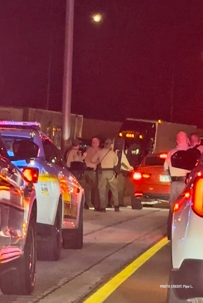 A witness snapped a photo as police carrying body shields approached the suspect's red vehicle, and as the photographer was stopped in traffic directly behind marked Cook County Sheriff's vehicles and Illinois State Police vehicles (PHOTO CREDIT: Pipe L.)