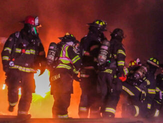 Firefighters positioned next to a car fire outside, advanced a hose to a fire involving vehicle fires and fire burning an attached garage in South Barrington on Sunday night, December 3, 2023