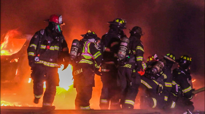 Firefighters positioned next to a car fire outside, advanced a hose to a fire involving vehicle fires and fire burning an attached garage in South Barrington on Sunday night, December 3, 2023