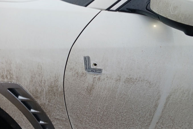 Bullet hole in the driver's side door of a white Infiniti that was struck when a shooter aimed at the vehicle near the intersection of Camp McDonald Road and Mandel Lane near the border of Prospect Heights and Mount Prospect Sunday night, January 21, 2024 (provided photo)
