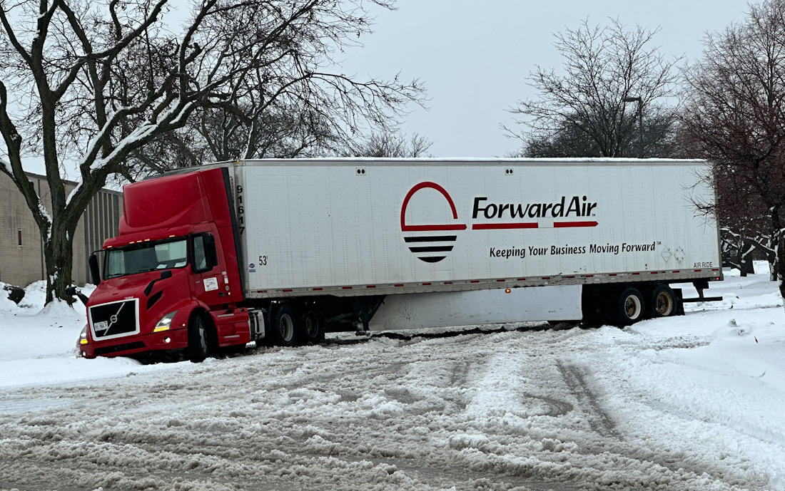 A semi-trailer truck got stuck in snow off King Street south of Lee Street and sits blocking King Street in Elk Grove Village at about 12:54 p.m. Friday, January 12, 2024 (CARDINAL NEWS)