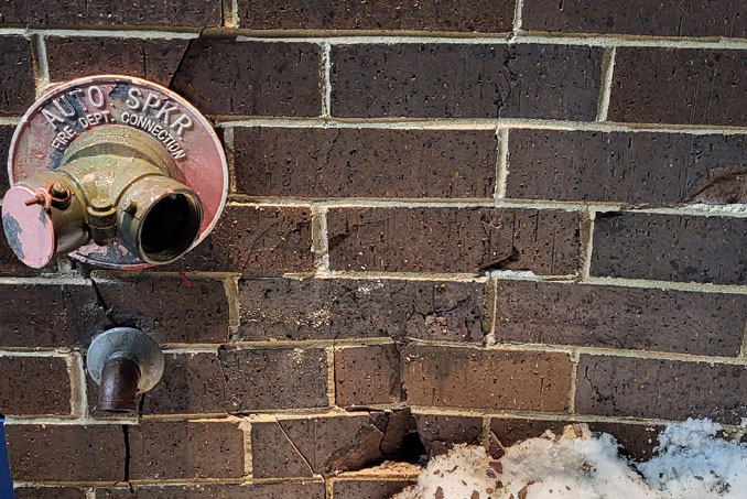 Brick damage near Automatic Sprinkler connection for the fire department at Culver's in Arlington Heights, Monday evening January 22, 2024 (PHOTO CREDIT: Chris Kobler)