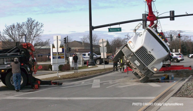 Scene of a rollover semi-trailer dump truck crash at Weiland Road and Aptakisic Road in Buffalo Grove, Thursday, January 4, 2024 (PHOTO CREDIT: Craig/CapturedNews)