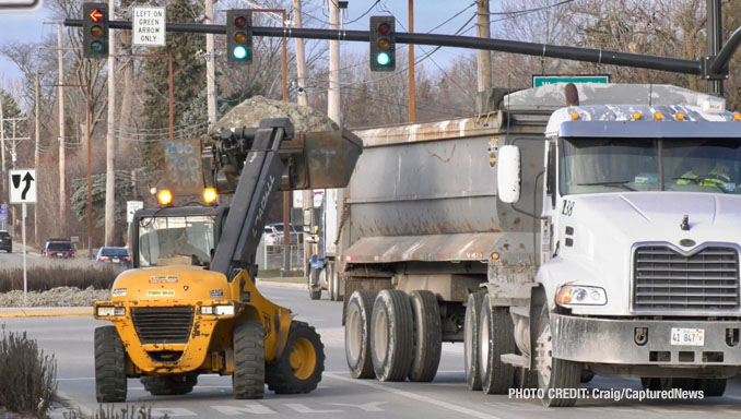 Removal of dumped lot to another semi-trailer dump truck at Weiland Road and Aptakisic Road in Buffalo Grove, Thursday, January 4, 2024 (PHOTO CREDIT: Craig/CapturedNews)