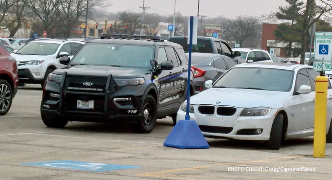 A Vernon Hills police SUV next to the white BMW 328i in Vernon Hills on Saturday, February 3, 2024 (Craig/CapturedNews)