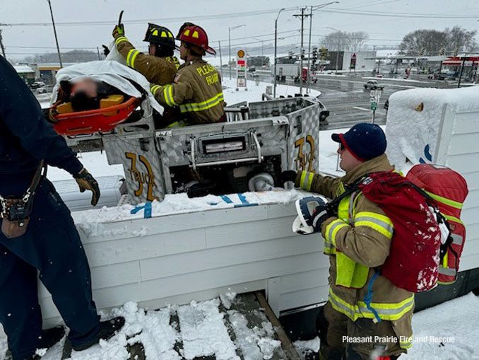 Construction worker in a Stokes basket on a Pleasant Prairie Fire & Rescue Tower Ladder Truck 32 during a rooftop rescue Friday, March 22, 2024 (SOURCE: Pleasant Prairie Fire & Rescue)