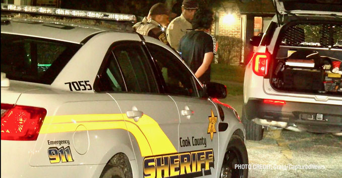 Cook County Sheriff's deputies transfer a male in custody in handcuffs from inside an apartment building to sheriff's police vehicle (PHOTO: Craig/CapturedNews)