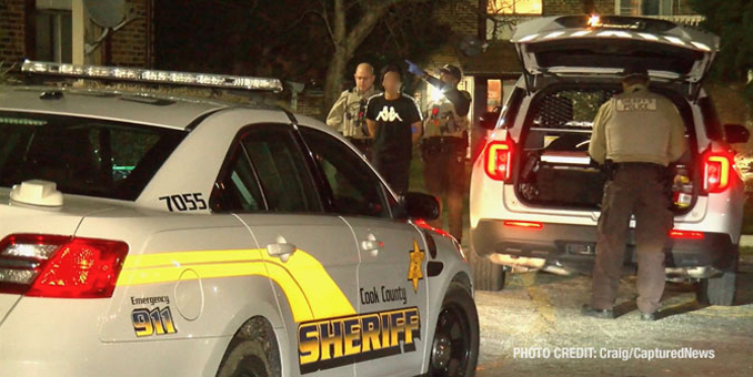 Cook County Sheriff's deputies transfer a male in custody in handcuffs from inside an apartment building to sheriff's police vehicle (PHOTO: Craig/CapturedNews)