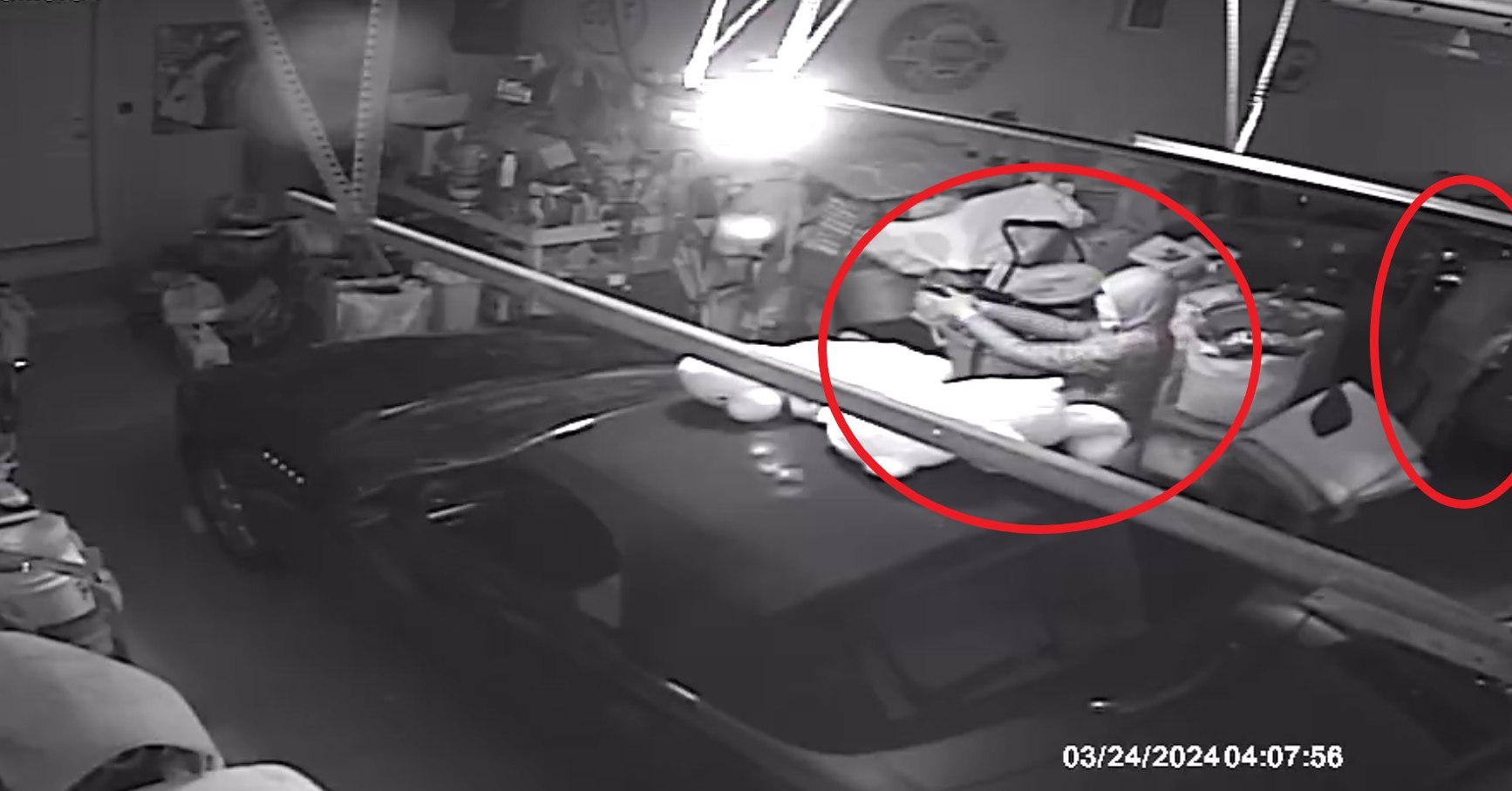 Criminal intruder prepared with a gun pointed at interior garage door into the living space of the home; consider the surprise and  level of alertness that a recently sleeping homeowner might have when opening their door to an alert, awake offender already pointing a gun at the door for cover while another offender is rummaging the door for valuables (SOURCE: Prospect Heights Police Department)