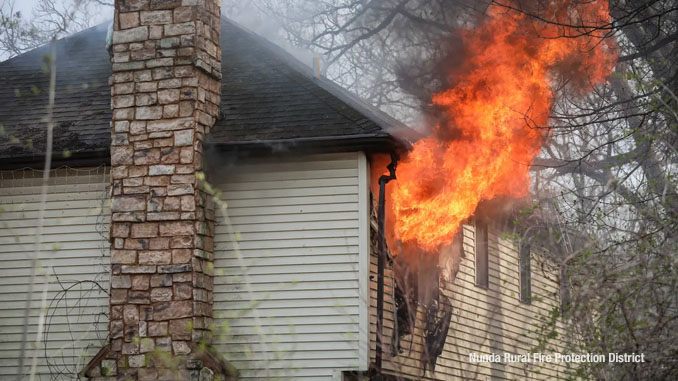 Flames erupt from a second floor window at the northwest corner of a home on Riverside Drive in unincorporated Crystal Lake Friday, March 29, 2024 (SOURCE: Nunda Rural Fire Protection District)