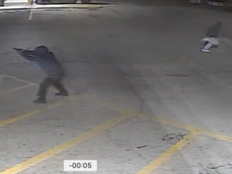 Suspect with gun raised in shots fired incident on Thursday night, March 21, 2024 in a strip mall near Milwaukee Avenue and Palatine Road (SOURCE: Prospect Heights Police Department)