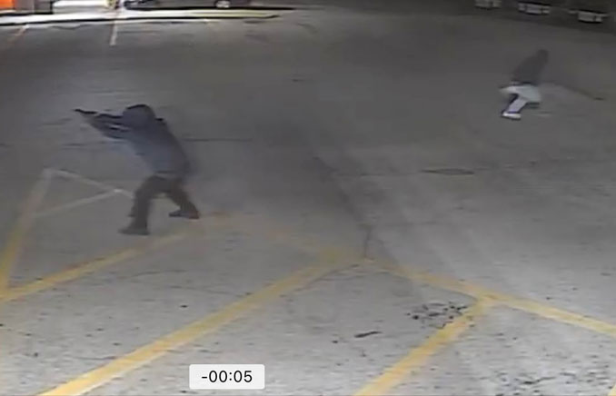 Suspect with gun raised in shots fired incident on Thursday night, March 21, 2024 in a strip mall near Milwaukee Avenue and Palatine Road (SOURCE: Prospect Heights Police Department)