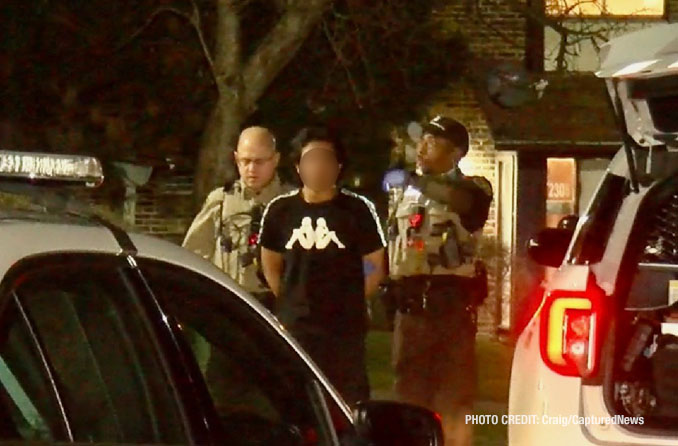 Cook County Sheriff's deputies transfer a male in custody in handcuffs from inside an apartment building to sheriff's police vehicle (PHOTO: Craig/CapturedNews)