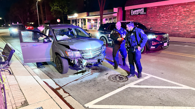 Police officer gathering information from a wrecked Dodge Journey after a crash with a tree on Arlington Heights Road just south of Northwest Highway about 2:30 a.m. Friday, April 19, 2024 (CARDINAL NEWS)