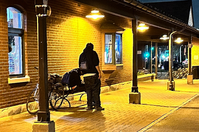 A male adult hangs his had forward while sitting on a bench on surrounded by vomit on Platform 2 near the Metra train station on Wednesday night, April 17, 2024