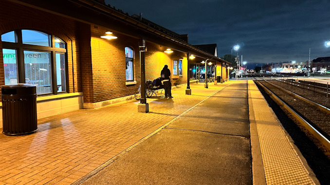 A male adult hangs his head forward while sitting on a bench surrounded by vomit on Platform 2 near the Metra train station on Wednesday night, April 17, 2024