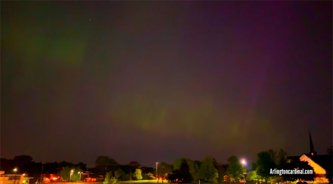Purplish Blue streak in Northern Lights begins to rise from church toward zenith in sky Saturday, May 11, 2024 after 3:00 a.m.