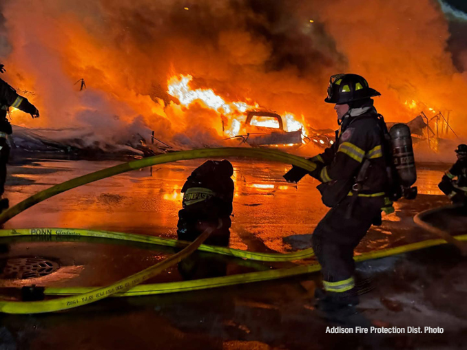 Firefighters working to extinguish a detached garage approximately 10vehicle carport in Bensenville in sub freezing temperatures Friday night January 24, 2025 (PHOTO CREDIT: Addison Fire Protection District)