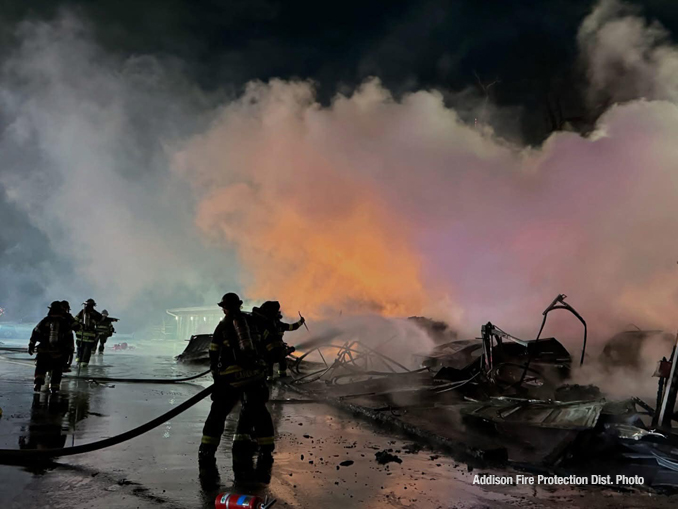 Firefighters working to extinguish a detached garage approximately 10vehicle carport in Bensenville in sub freezing temperatures Friday night January 24, 2025 (PHOTO CREDIT: Addison Fire Protection District)