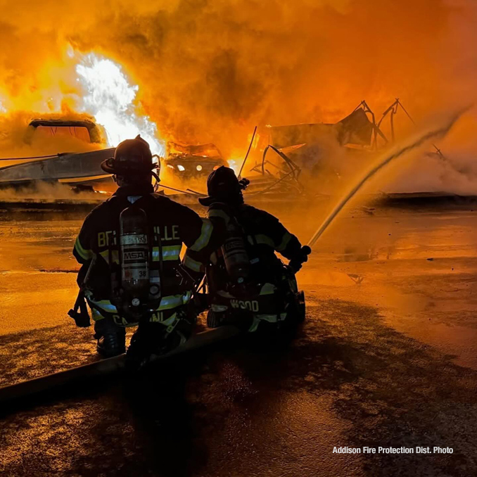 Firefighters working to extinguish a detached garage approximately 10vehicle carport in Bensenville in sub freezing temperatures Friday night January 24, 2025 (PHOTO CREDIT: Addison Fire Protection District)