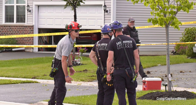 Fire department technical rescue and stabilization experts at the scene of a car crash into a garage on Kessler Drive in Mundelein, Saturday evening, July 19, 2025 (Craig/CapturedNews)