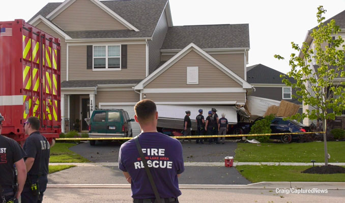 Fire department technical rescue and stabilization experts at the scene of a car crash into a garage on Kessler Drive in Mundelein, Saturday evening, July 19, 2025 (Craig/CapturedNews)