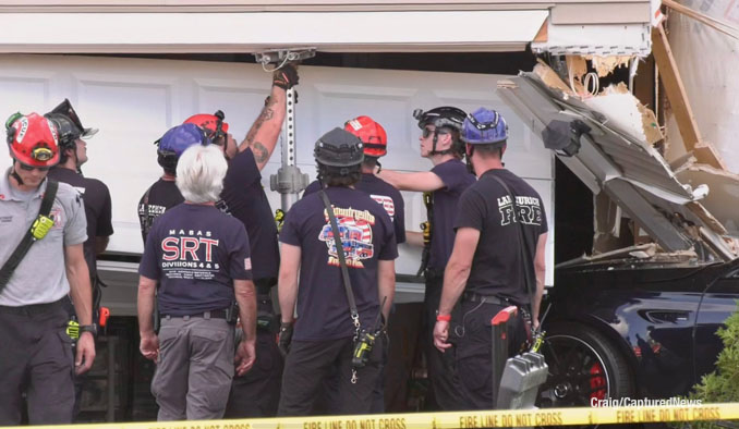 Fire department technical rescue and stabilization experts at the scene of a car crash into a garage on Kessler Drive in Mundelein, Saturday evening, July 19, 2025 (Craig/CapturedNews)