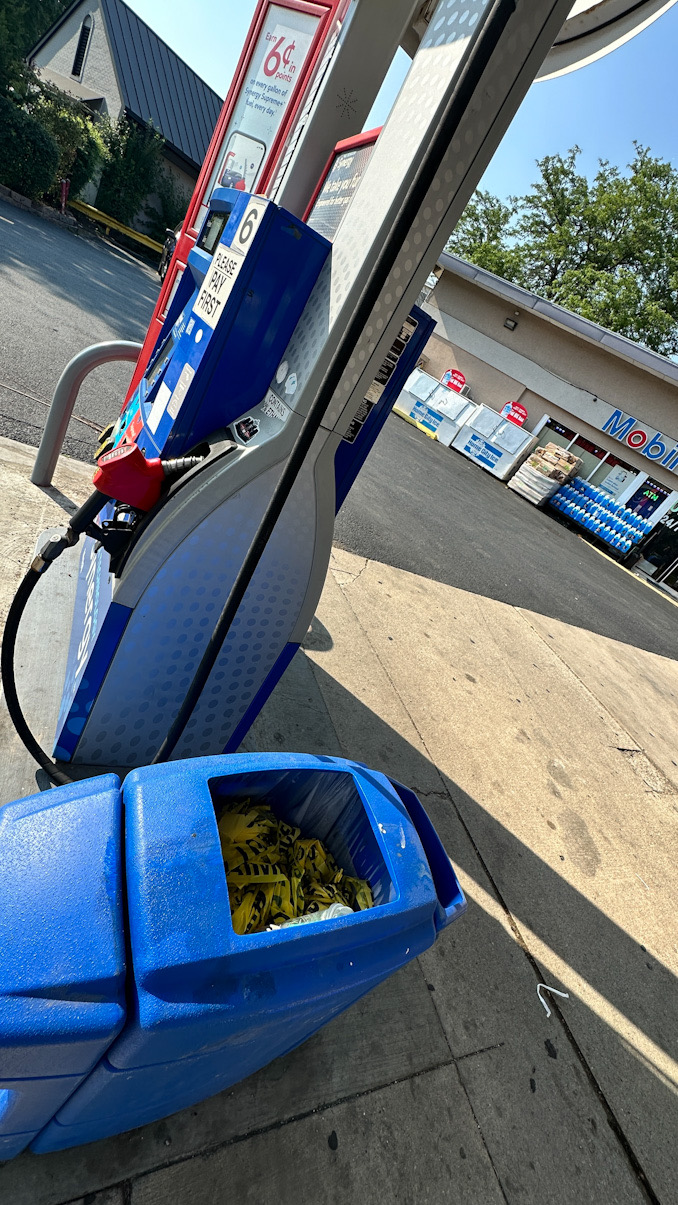 Yellow crime scene tape in the garbage at the Mobil gas station at Northwest Highway and Vail Avenue in Arlington Heights, Tuesday afternoon, August 5, 2025 (CARDINAL NEWS)