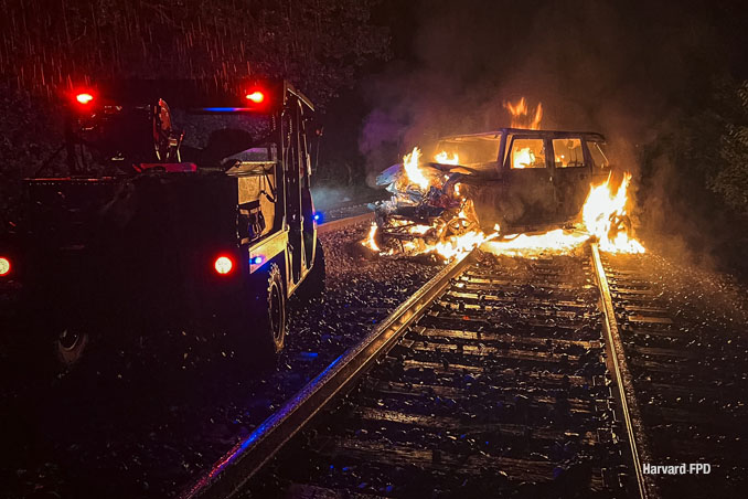 Burning vehicle after crash with a freight train on Union Pacific Northwest line between Harvard and Woodstock in McHenry County, Thursday, August 28, 2025 (SOURCE: Harvard Fire Protection District)