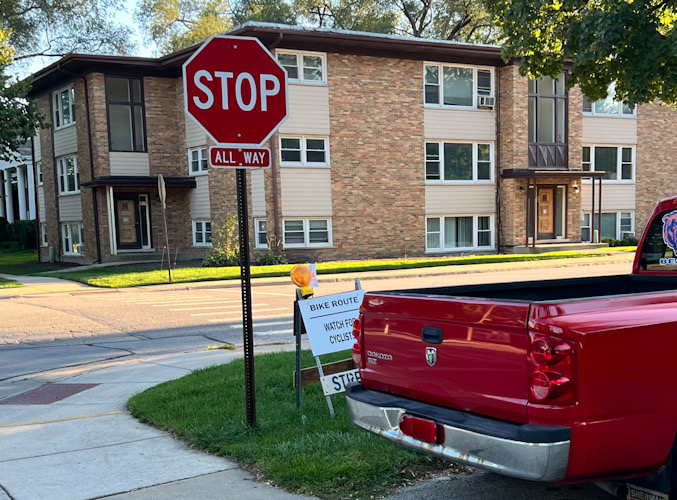 Examples of poor judgment for Bike Route sign implementation in Arlington Heights at northbound Dryden Place and Miner Street:  Sign is not reflective, not affixed, violates requirement that signs involving different decisions be sufficiently spaced apart, violates requirement that signs in residential areas are a minimum of 7 feet from the bottom of the sign to the top of the curb (SOURCE: Federal Highway Administration Manual on Uniform Traffic Control Devices)