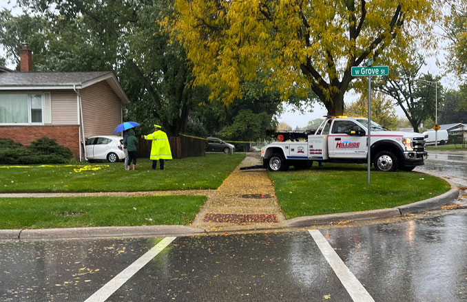 Small white cross over SUV crashed into a house at Wilke Road and Grove Street in Arlington Heights, Sunday, October 19, 2025 (SOURCE: Provided to CARDINAL NEWS via the "FASTEST/EASIEST" FORM on the CARDINAL NEWS NOTIFY PANEL)