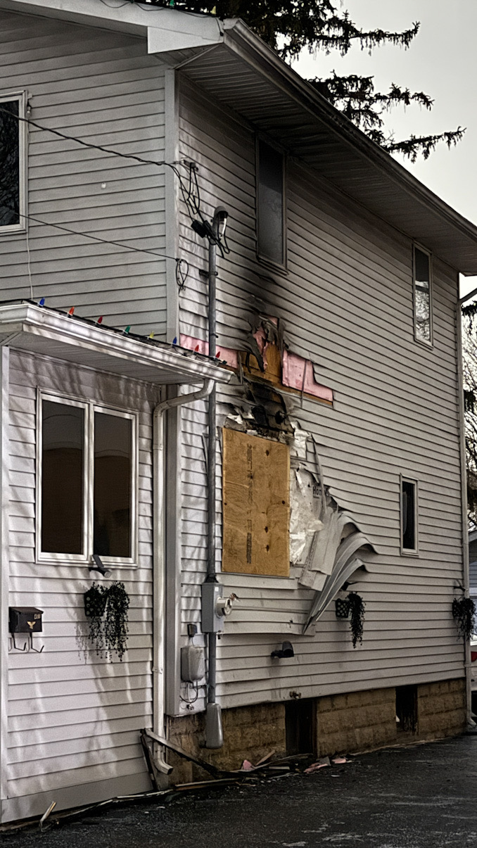 A hole caused by the fire was boarded up at the scene of the house fire on Wing Street just west of downtown Arlington Heights (CARDINAL NEWS)
