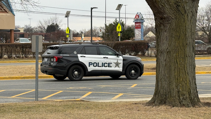 Arlington Heights police officer in SUV Ford Interceptor completing report of incident near Thomas Street and Waterman Avenue at John Hersey High School (CARDINAL NEWS)