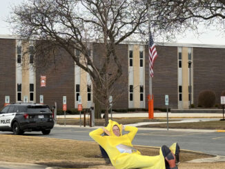 Serious Village Manager concerned with public safety transparency, or wannabe social media star? Transformative work ("Fair Use") includes image of Arlington Heights police officer in SUV Ford Interceptor completing report of incident near Thomas Street and Waterman Avenue at Hersey High School by CARDINAL NEWS and social media work on X by Village Manager Randall Recklaus