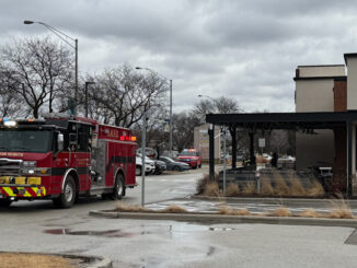 Arlington Heights Fire Department Engine 2 sits outside in the front of Raising Cane's while firefighters check out the interior of Raising Cane's restaurant, 225 East Palatine Road in Arlington Heights (CARDINAL NEWS)