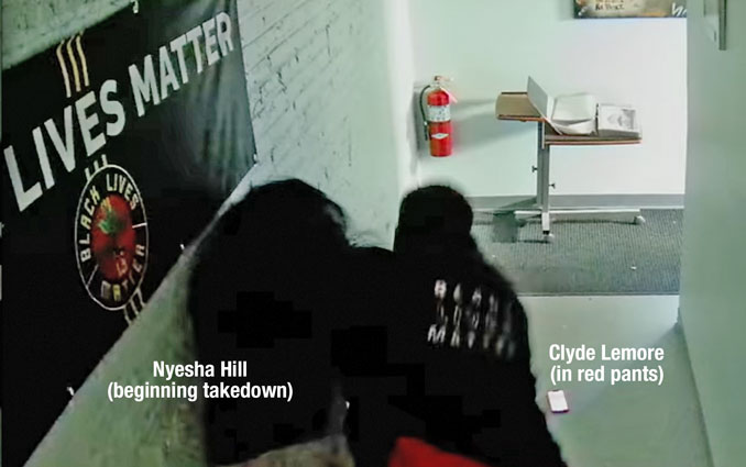 Nyesha Hill begins takedown of Clyde McLemore during physical altercation on October 24, 2025 captured on Black Lives Matter surveillance video (SOURCE: Surveillance video Lake County Resource Center Waukegan)