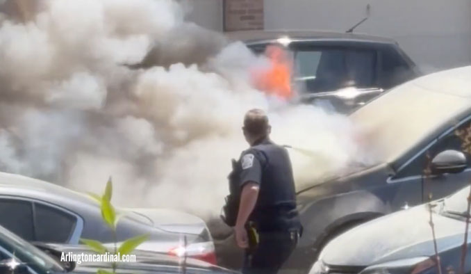 An Arlington Heights police officer attempts to extinguish a vehicle fire with a fire extinguisher while Arlington Heights firefighters were delayed for an unknown reason. SInce police officers are often already on the street, they often arrive first at risky scenes and are often placed in harm's way before firefighters arrive (CARDINAL NEWS)