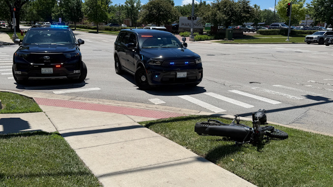 Arlington Heights police vehicles protecting the scene at the northeast corner of Dryden Place and Kensington Road in Arlington Heights on Friday, June 12, 2026 (CARDINAL NEWS)