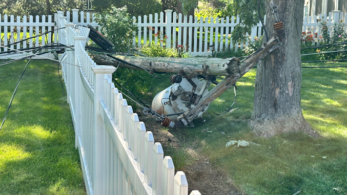 One of two old backyard utility poles that collapsed in backyards in the block of 700 North Douglas Avenue in Arlington Heights Tuesday afternoon, July 14, 2026 (CARDINAL NEWS)