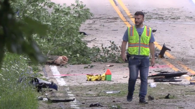 An MCAT investigator walks near high-speed crash debris on Brinker Road near Hills and Dales Road in Barrington Hills the morning after a single-vehicle crash overnight Friday/Saturday, July 25, 2026 (CapturedNews).