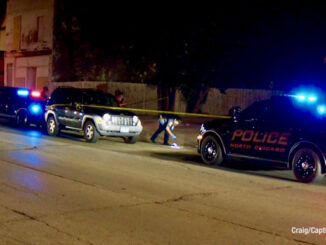 Police investigate a fatal stabbing crime scene near a Jeep Liberty on 10th Street in North Chicago (PHOTO CREDIT: Craig/CapturedNews).
